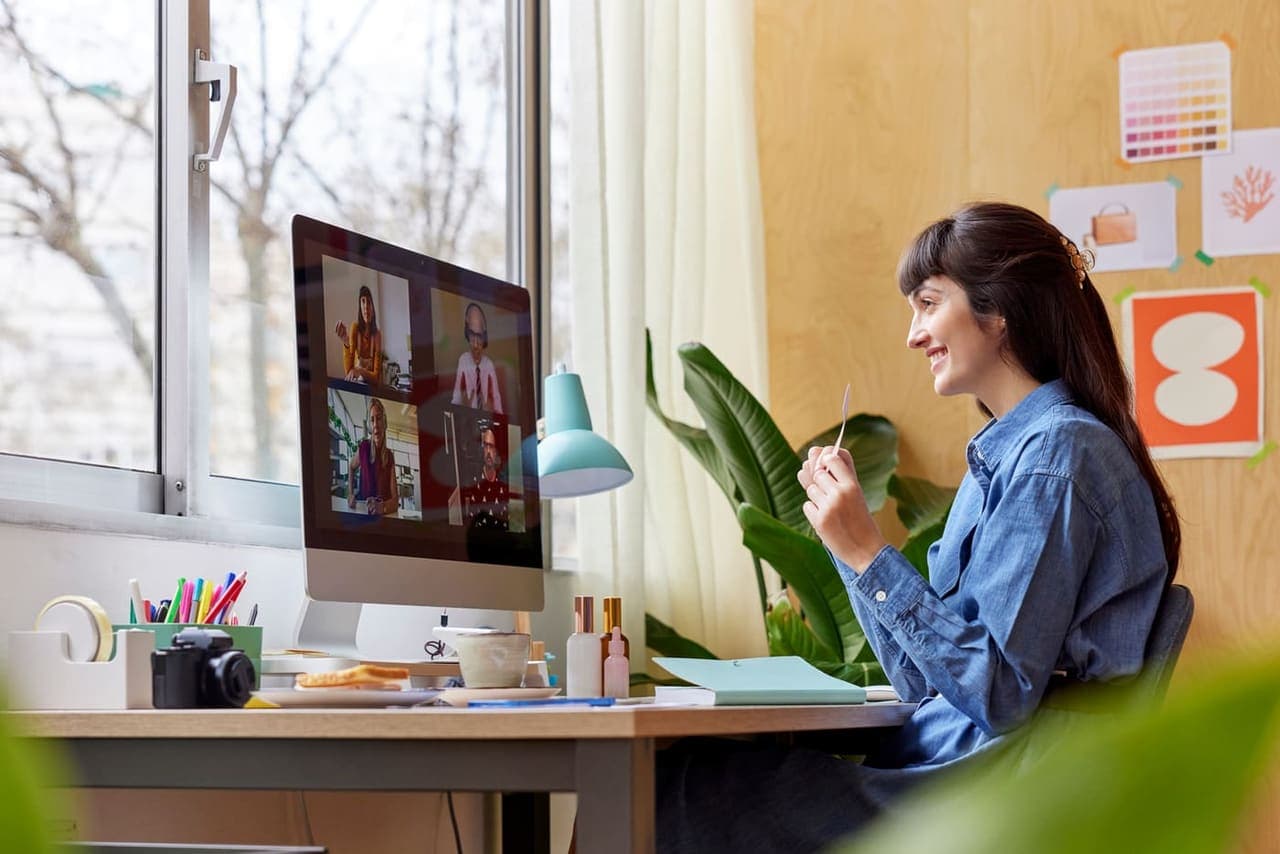 Coach smiling on a video call with clients