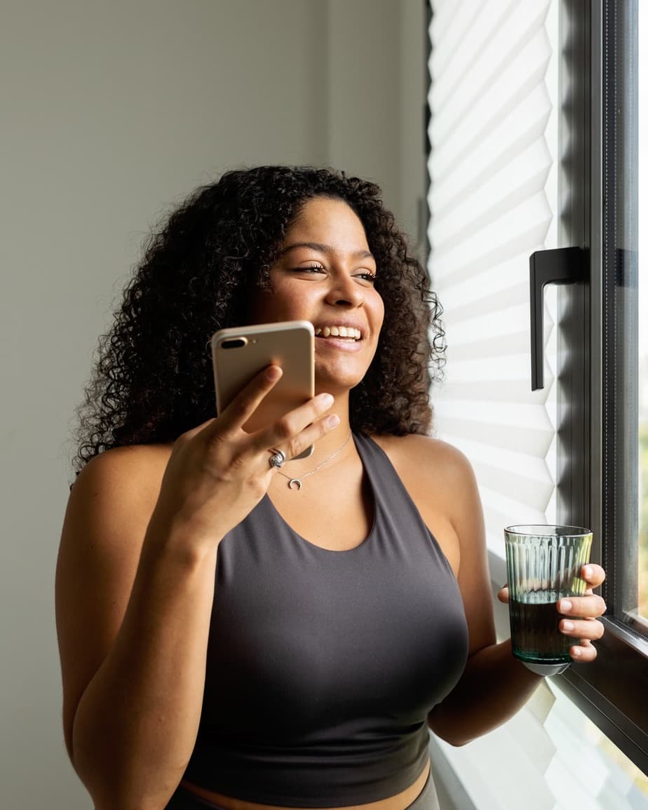 Coaching client checking progress updates on her phone